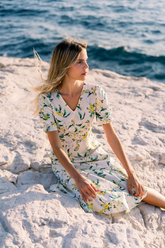 a lady in a white floral printed silk dress